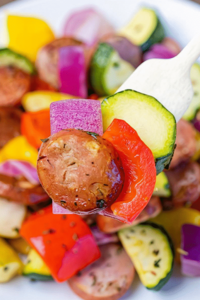 Close-up of cooked chicken apple sausage with vegetables in air fryer