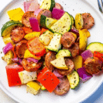 Plated chicken apple sausage air fryer dish with roasted vegetables